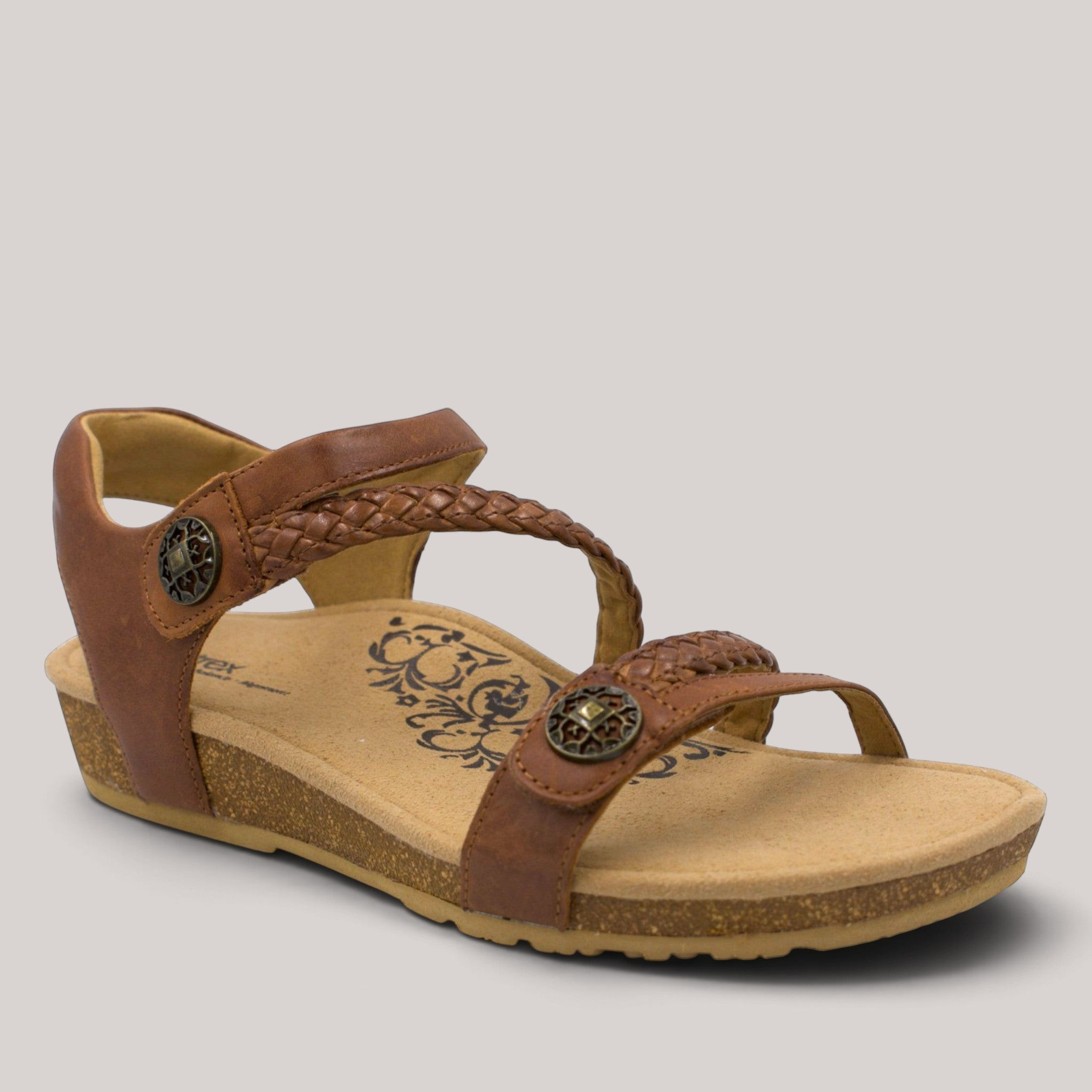 Grundy's Shoes Aetrex Jillian brown leather sandal with braided straps, cork midsole, and decorative metal accents.