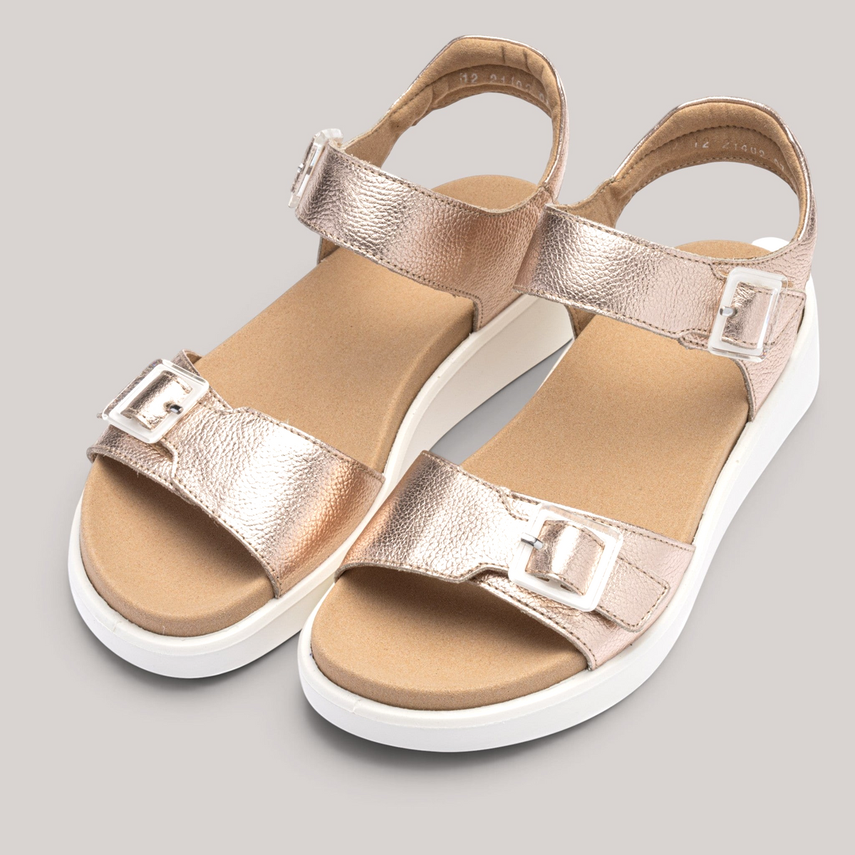 Grundy's Shoes Ara Madeira metallic rose gold leather sandals with white wedge soles and decorative buckles.