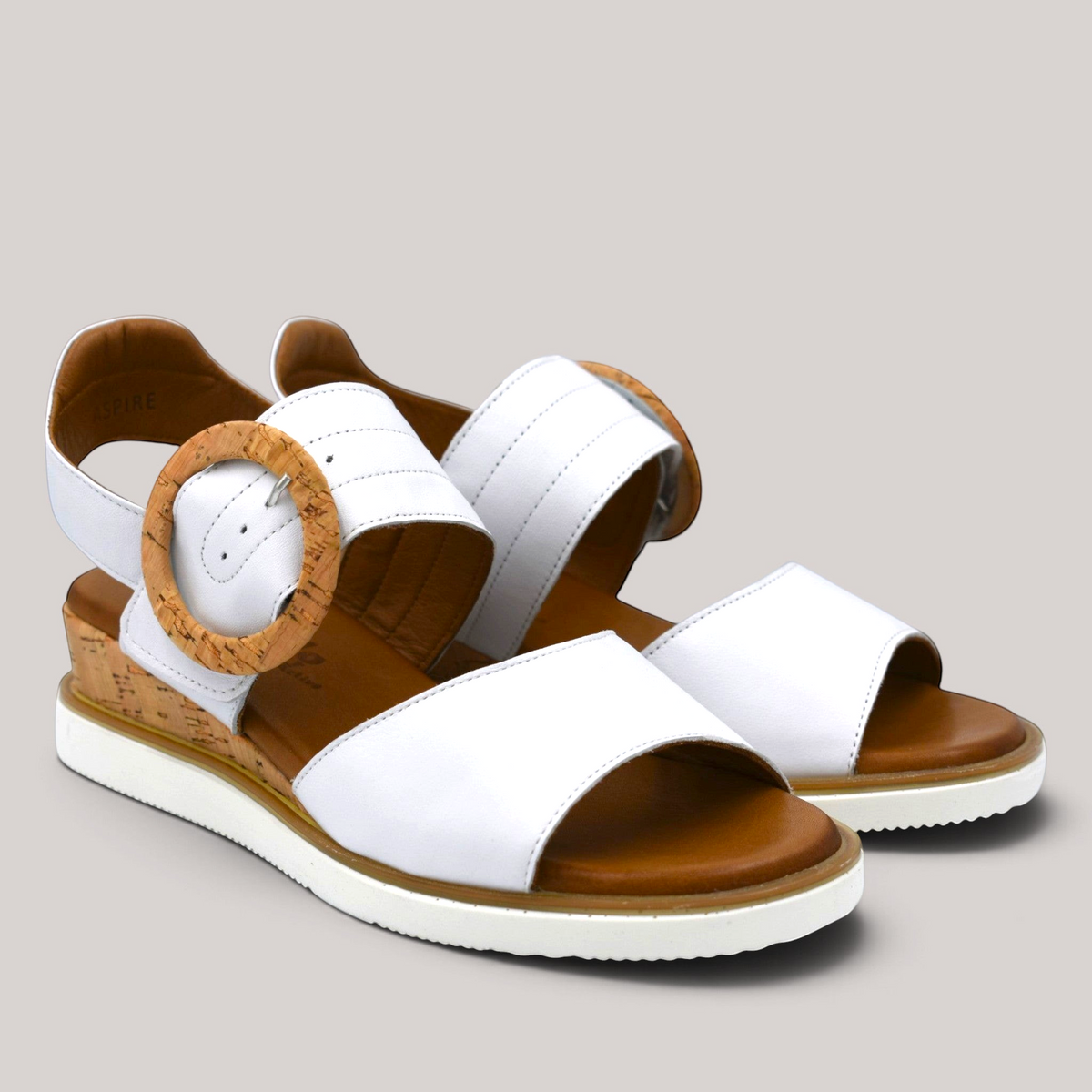 Grundy's Shoes Cabello Aspire white leather wedge sandals with a cork-look buckle and comfortable brown insole.