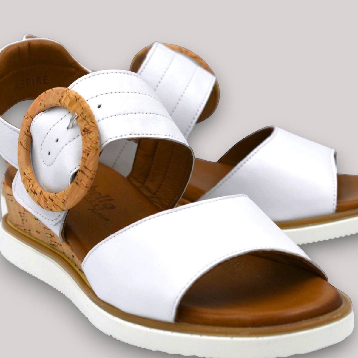 Grundy's Shoes Cabello Aspire white leather wedge sandals with a cork-look buckle and comfortable brown insole.