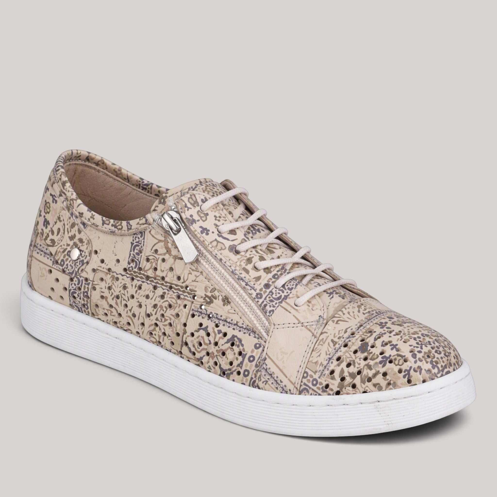 Grundy's Shoes Cabello EG17P beige leather sneaker with laser-cut floral patterns, side zipper, and white sole.
