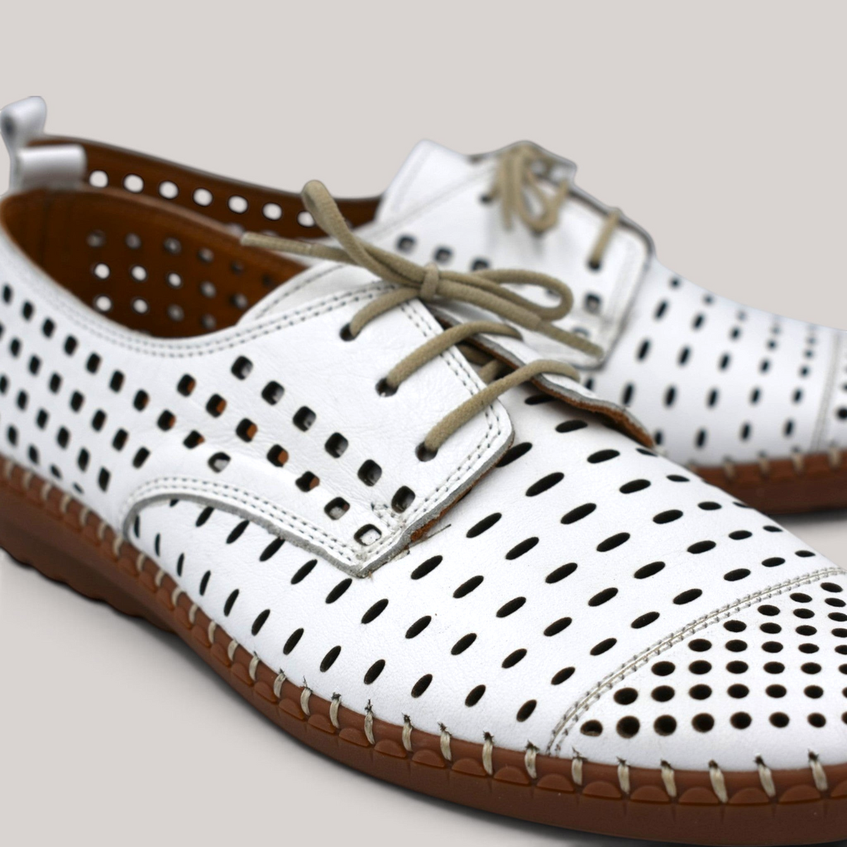 Grundy's Shoes Cabello Kroon white perforated leather lace-up shoes with brown stitched sole and padded insole.