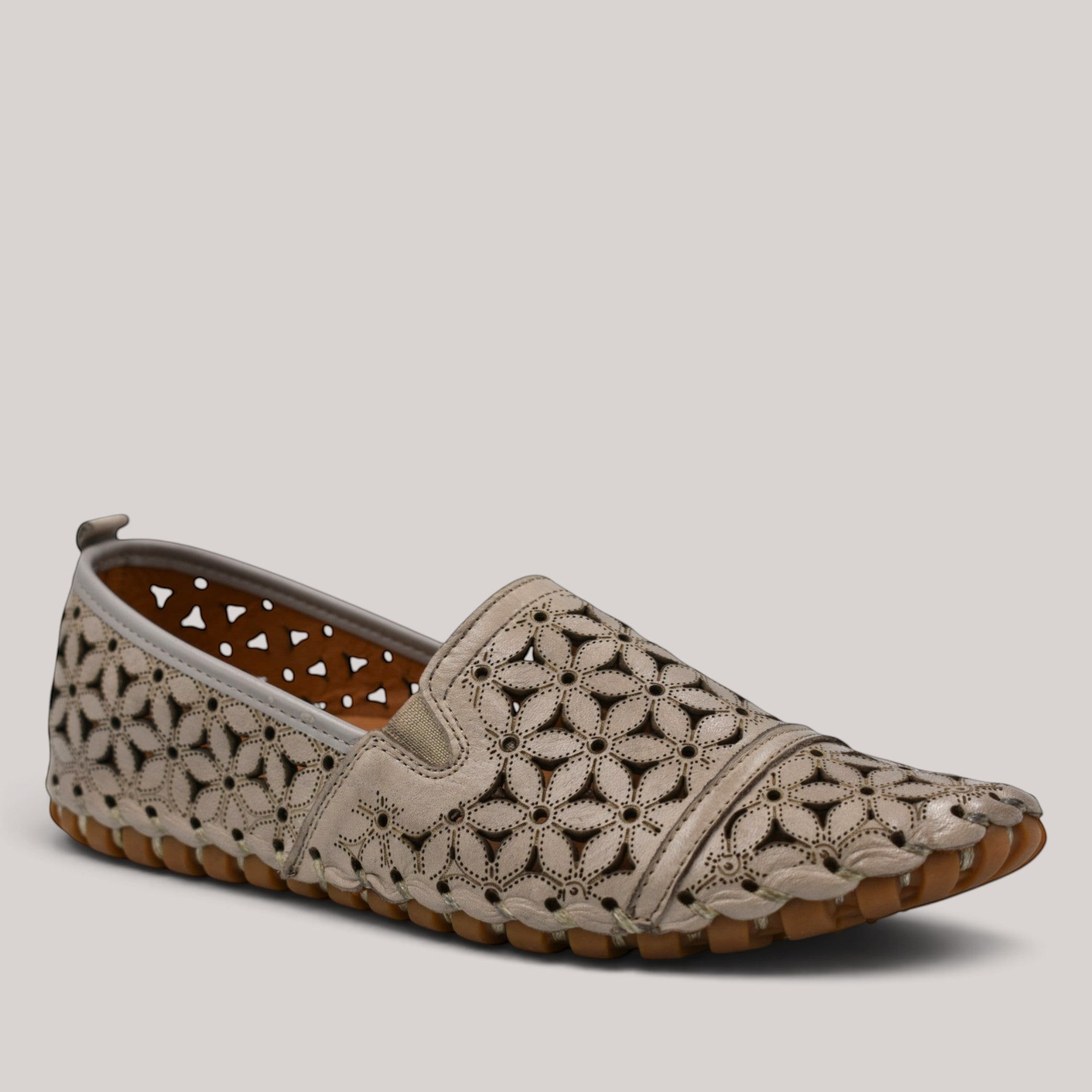 Grundy's Shoes Cabello Muriel beige leather slip-on shoe with floral laser-cut details and a durable rubber sole.