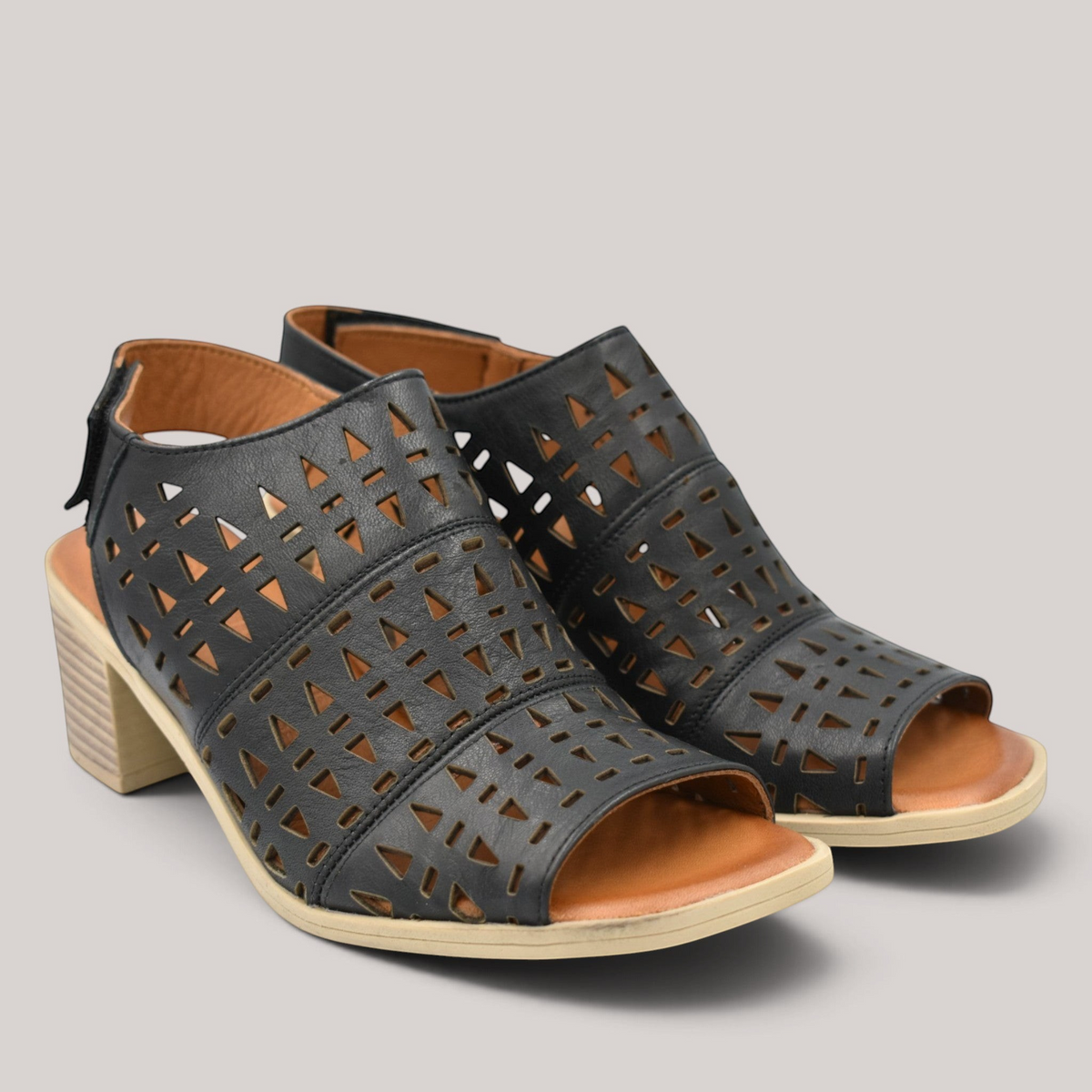 Grundy's Shoes Cabello Wilder black leather sandals with punched geometric cutouts, square toe, and block heel.