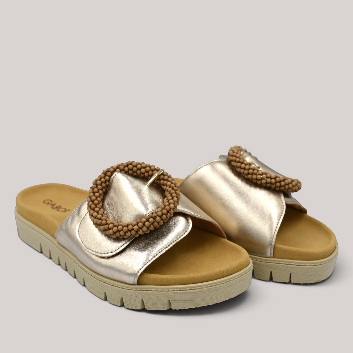 Grundy's Shoes Gabor 83745 metallic gold leather slide sandals with a beaded buckle and contoured footbed.