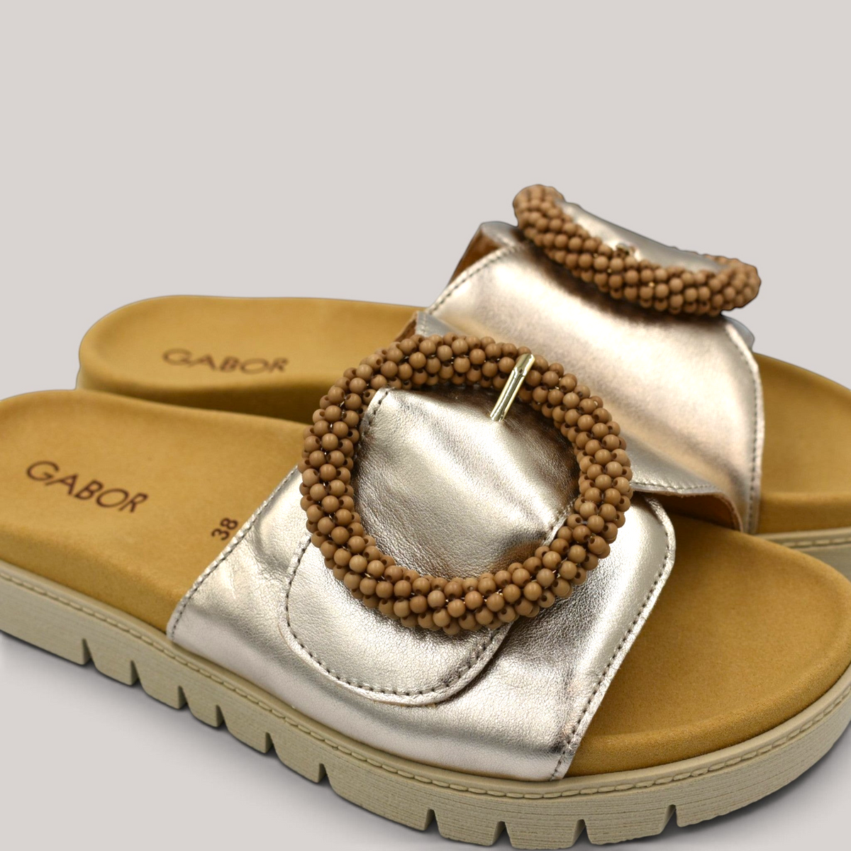 Grundy's Shoes Gabor 83745 metallic leather slide sandals with a beaded buckle and contoured footbed.