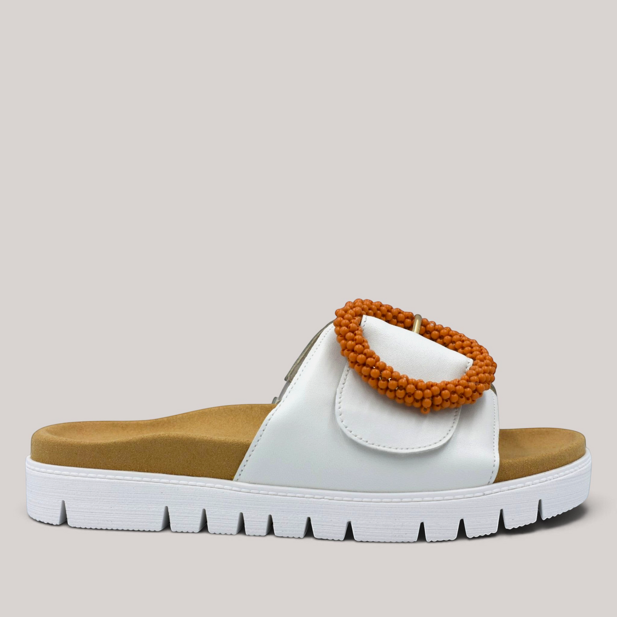 Grundy's Shoes Gabor white leather slide sandal with a tan contoured footbed and oversized beaded buckle detail.