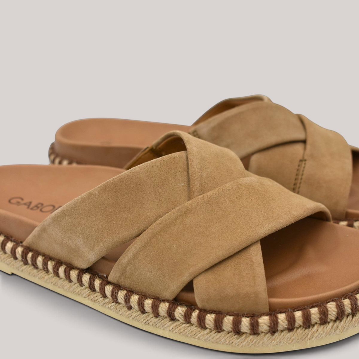 Grundy's Shoes Gabor 83780 beige suede slide sandals with cross-over straps and a decorative espadrille-style trim.