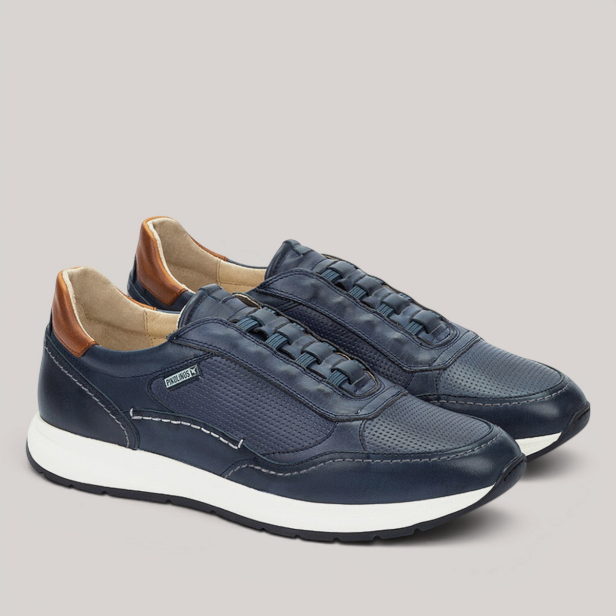 Grundy's Shoes Pikolinos Getafe navy leather trainers with perforated details, white sole, and brown heel tab.