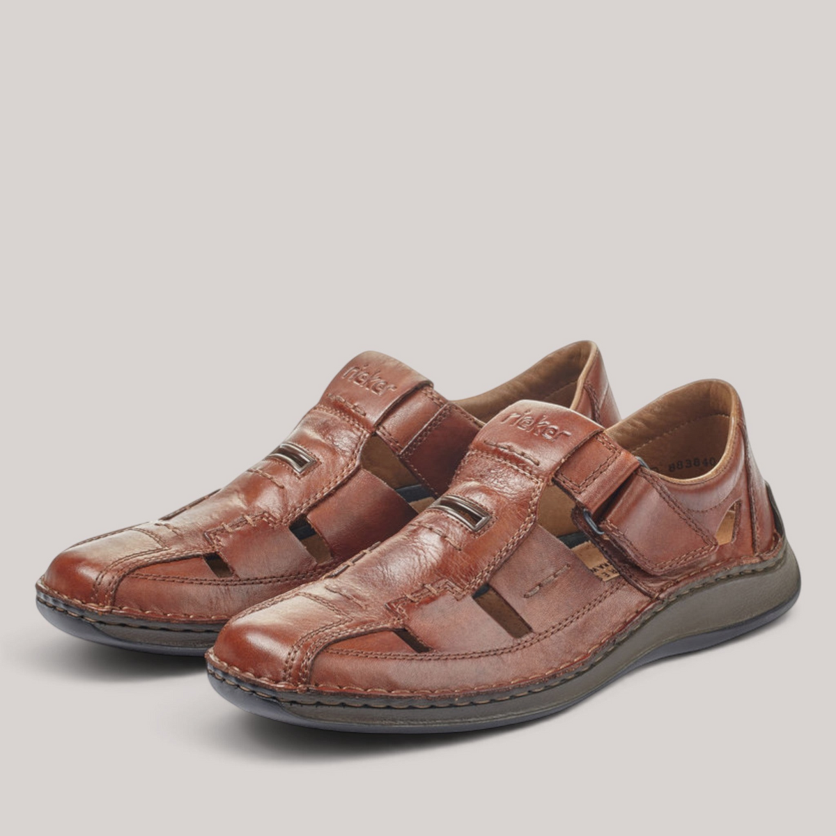 Grundy's Shoes Rieker brown leather sandals with adjustable Velcro straps and cushioned shock-absorbing soles.
