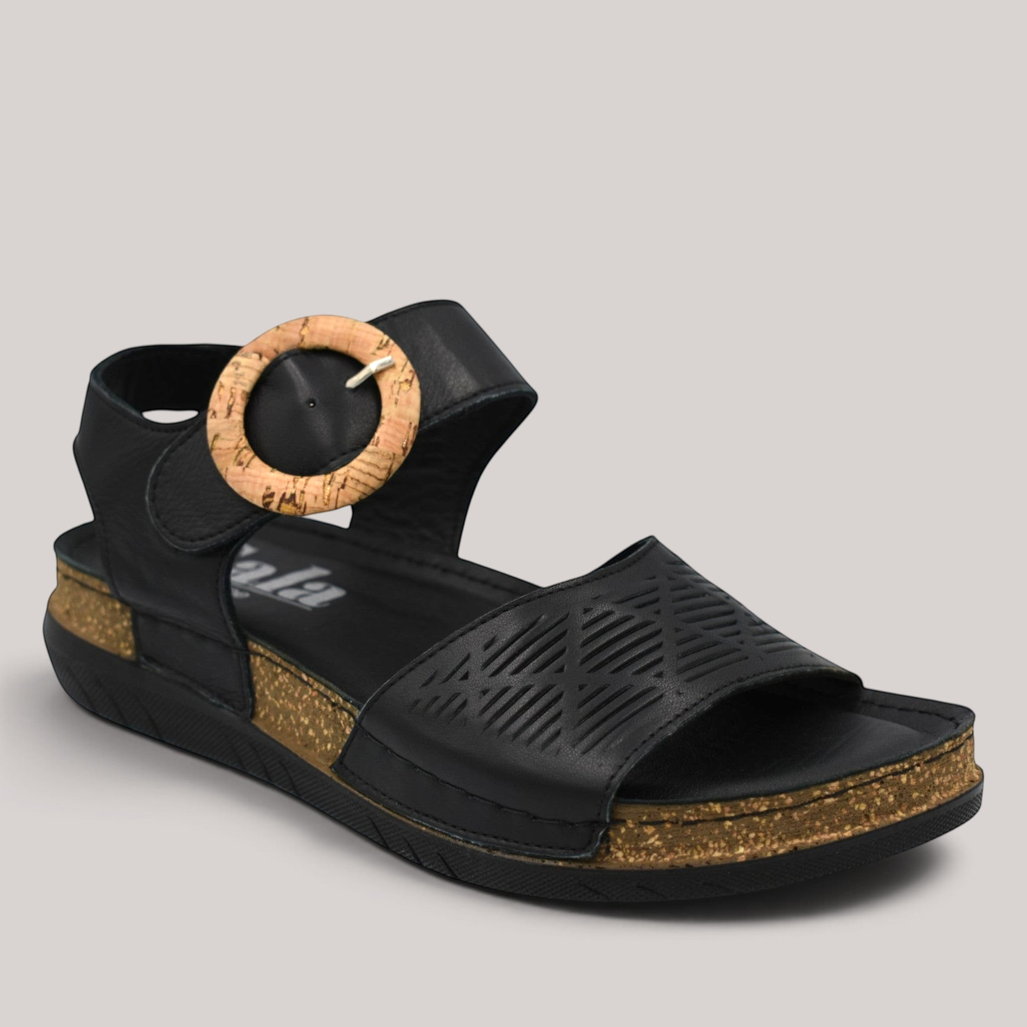 Grundy's Shoes Sala Miles black leather sandal with a decorative cork-look buckle and adjustable Velcro ankle strap.