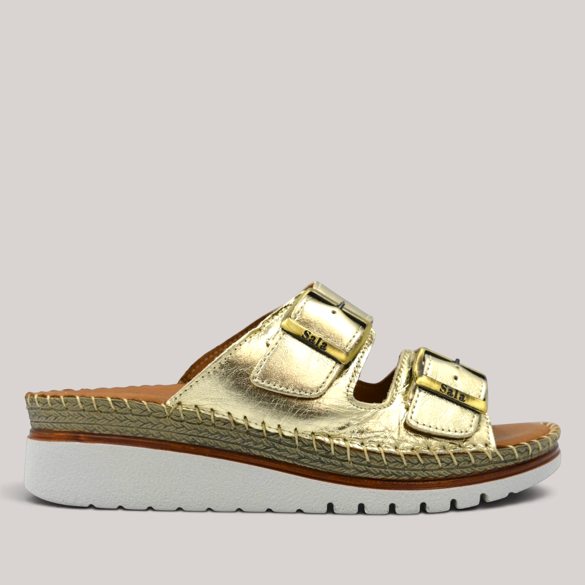 Grundy's Shoes Sala Oasis gold leather slip-on sandals with adjustable buckle straps and a cushioned platform sole.
