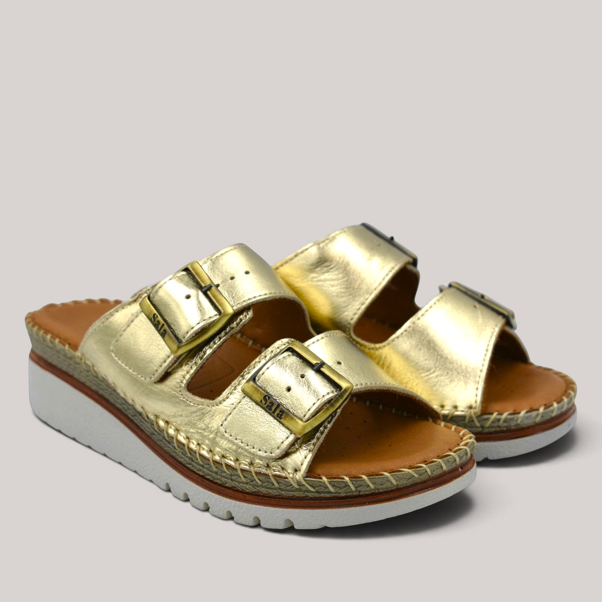 Grundy's Shoes Sala Oasis gold leather slip-on sandals with adjustable straps and a cushioned platform sole