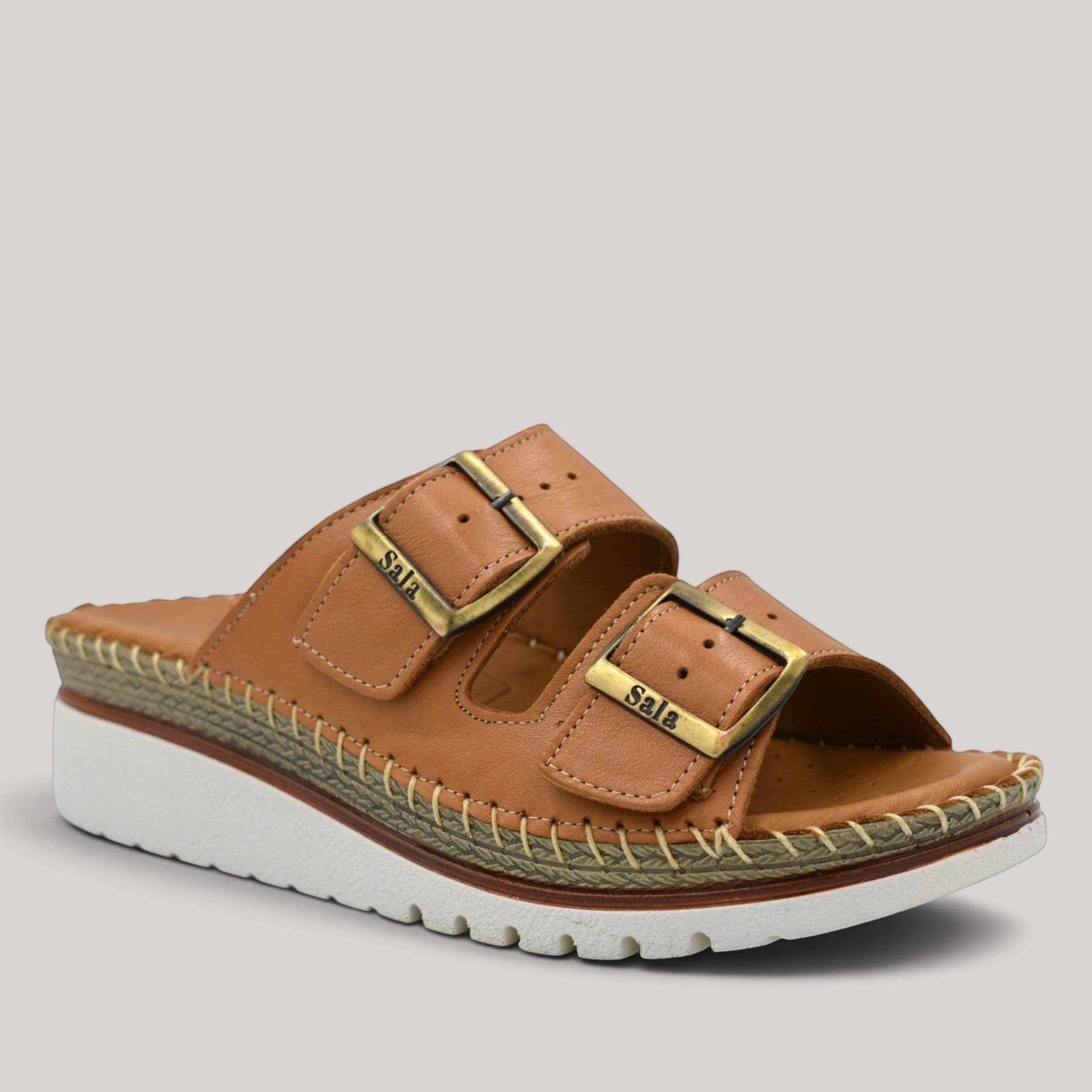 Grundy's Shoes Sala Oasis tan leather slip-on sandals with two adjustable buckle straps and a white platform sole.