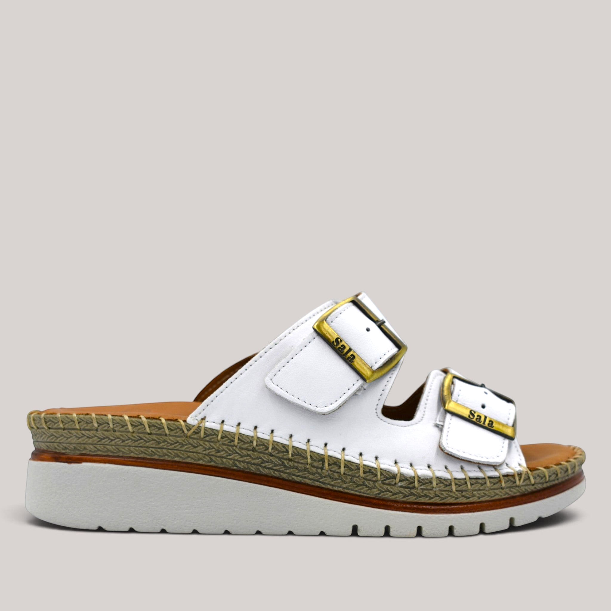 Grundy's Shoes Sala Oasis white leather slip-on sandals with adjustable buckles and a cushioned platform sole.
