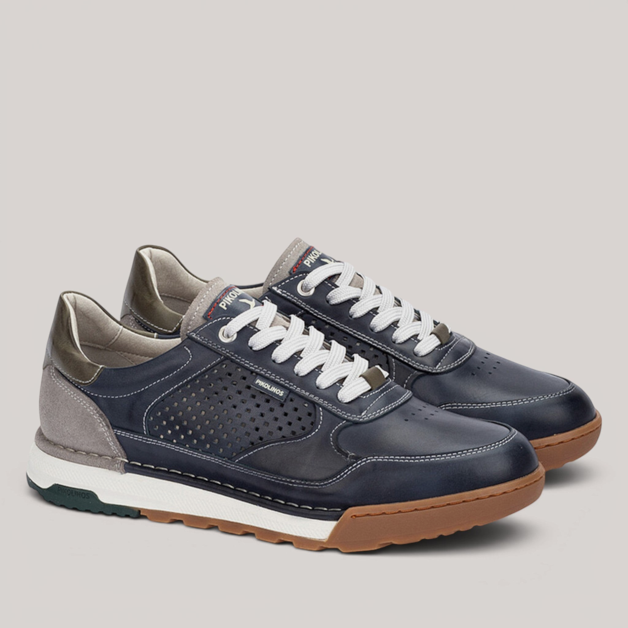 Grundy's Shoes Pikolinos Teide navy leather trainers with white laces, perforated side panels, and gum rubber soles.