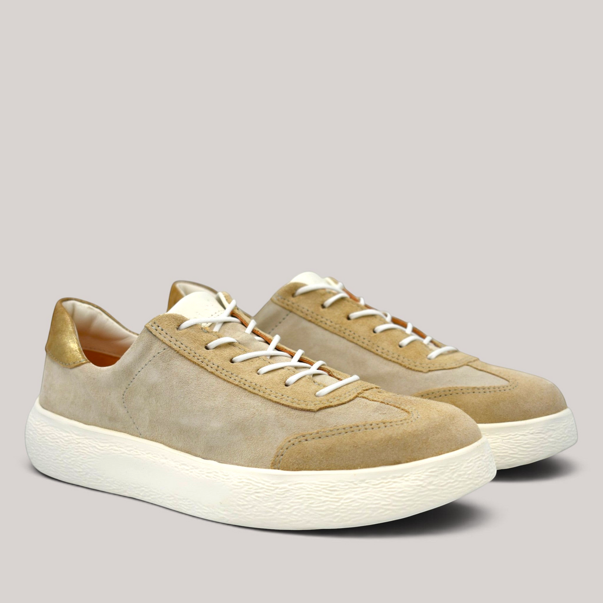 Grundy's Shoes Think lace-up sneaker in beige suede and nubuck leather with a gold heel tab and white rubber sole.