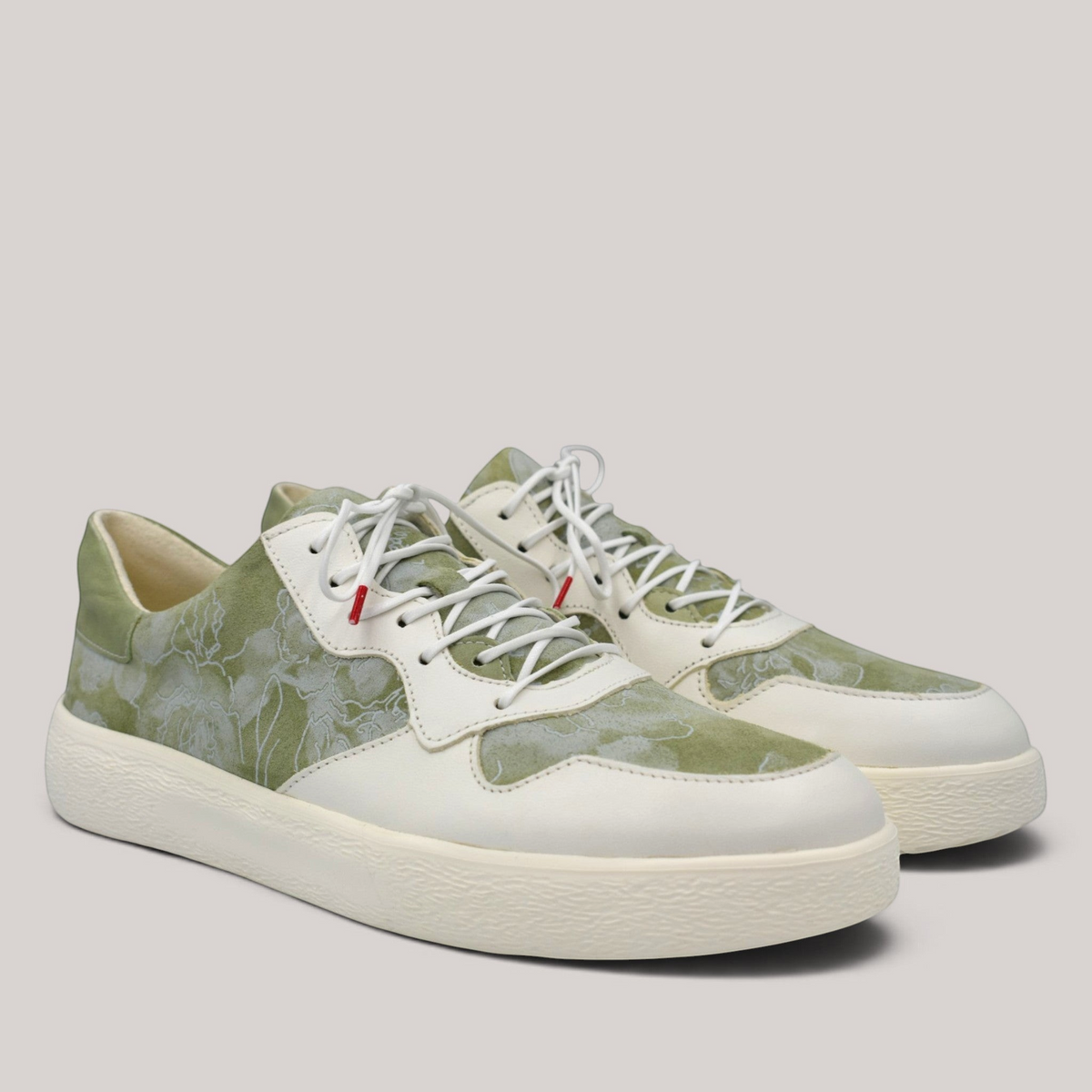 Grundy's Shoes Think 001303 lace-up sneakers in sage green and cream leather with a floral pattern and white soles.