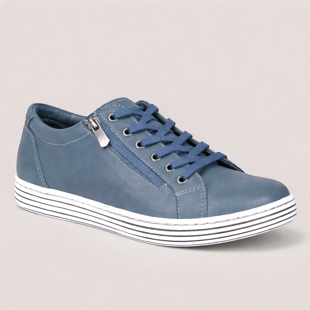 Grundy's Shoes Cabello Unity blue leather sneaker with side zip, laces, and a striped white sole.