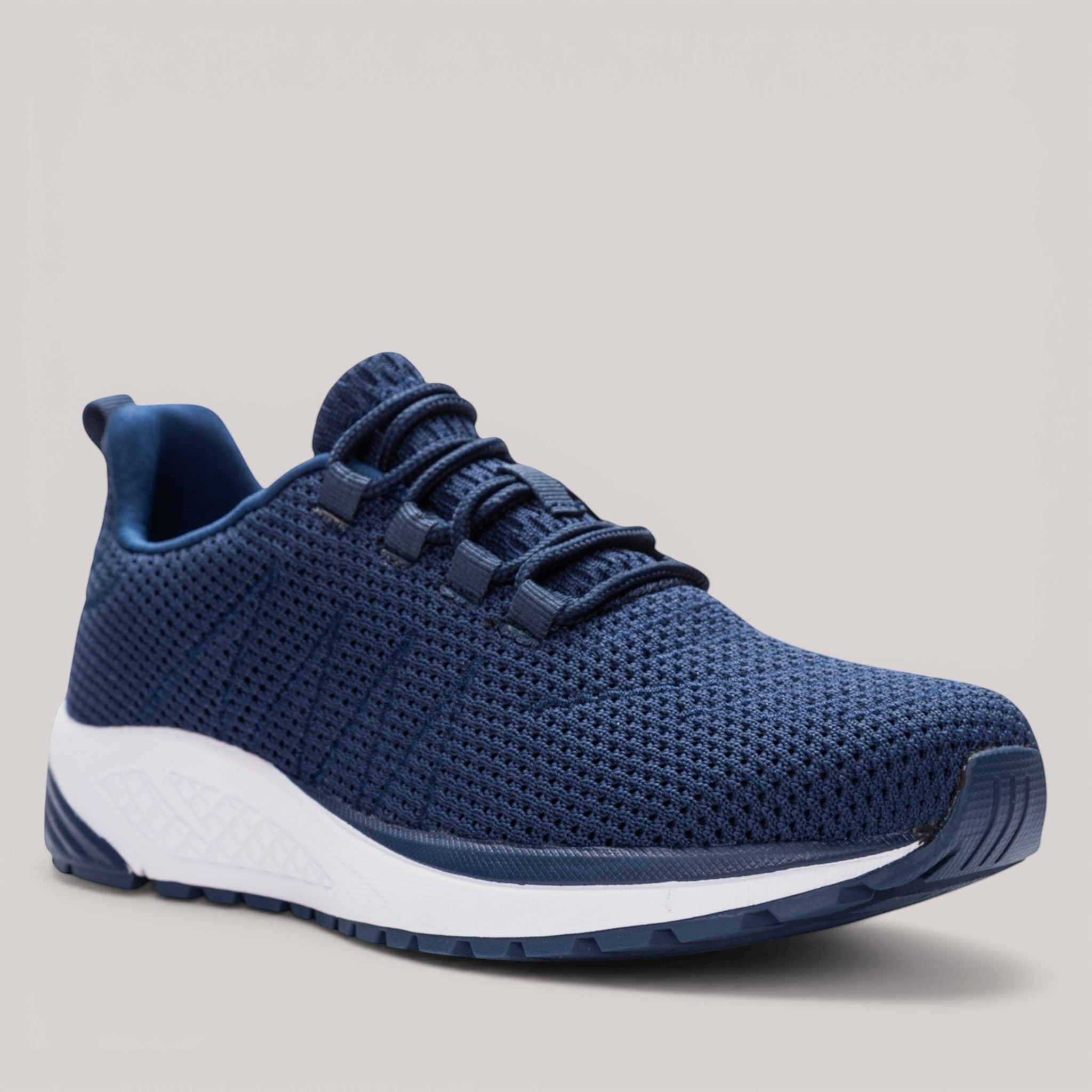 Grundy's Shoes Propet Tour Knit women's navy blue mesh sneaker with a white EVA midsole and cushioned performance sole.