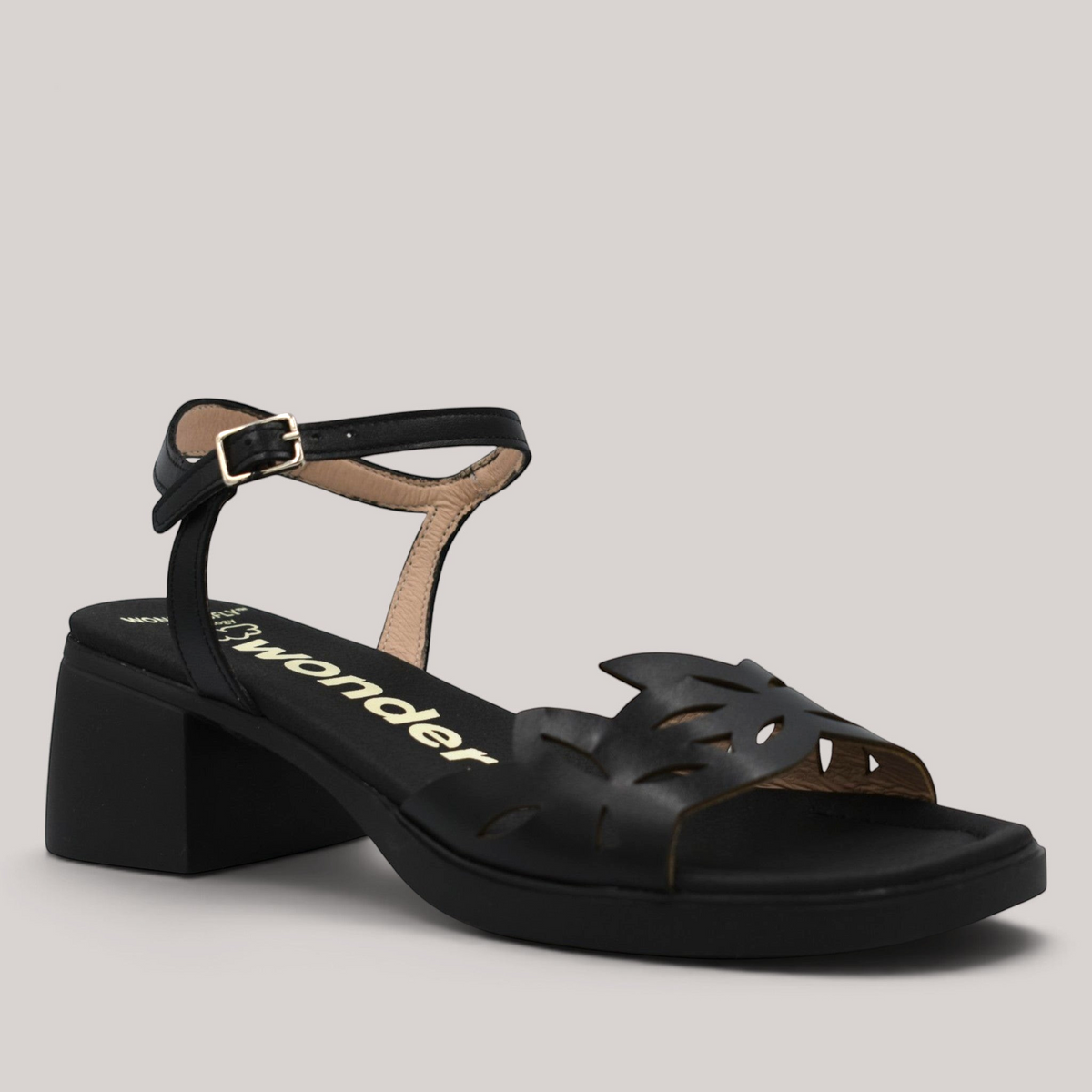 Grundy's Shoes Wonders 2301 black leather sandals with floral die-cut vamp, adjustable buckle strap, and block heel.