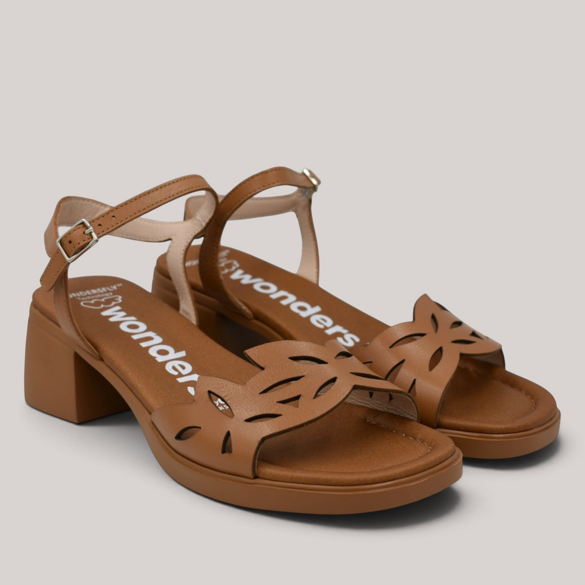 Grundy's Shoes Wonders 2301 tan leather sandals with floral die-cut vamp, adjustable buckle strap, and block heel.