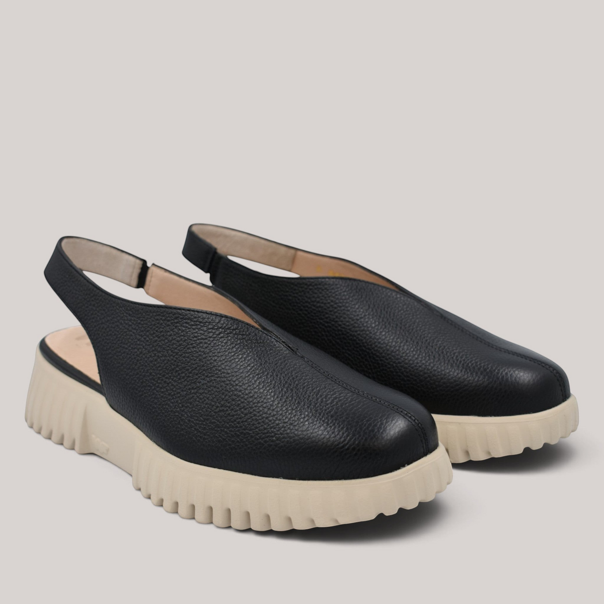 Grundy's Shoes Wonders 4411 black leather slingback shoes with a beige lightweight platform sole and open back design.