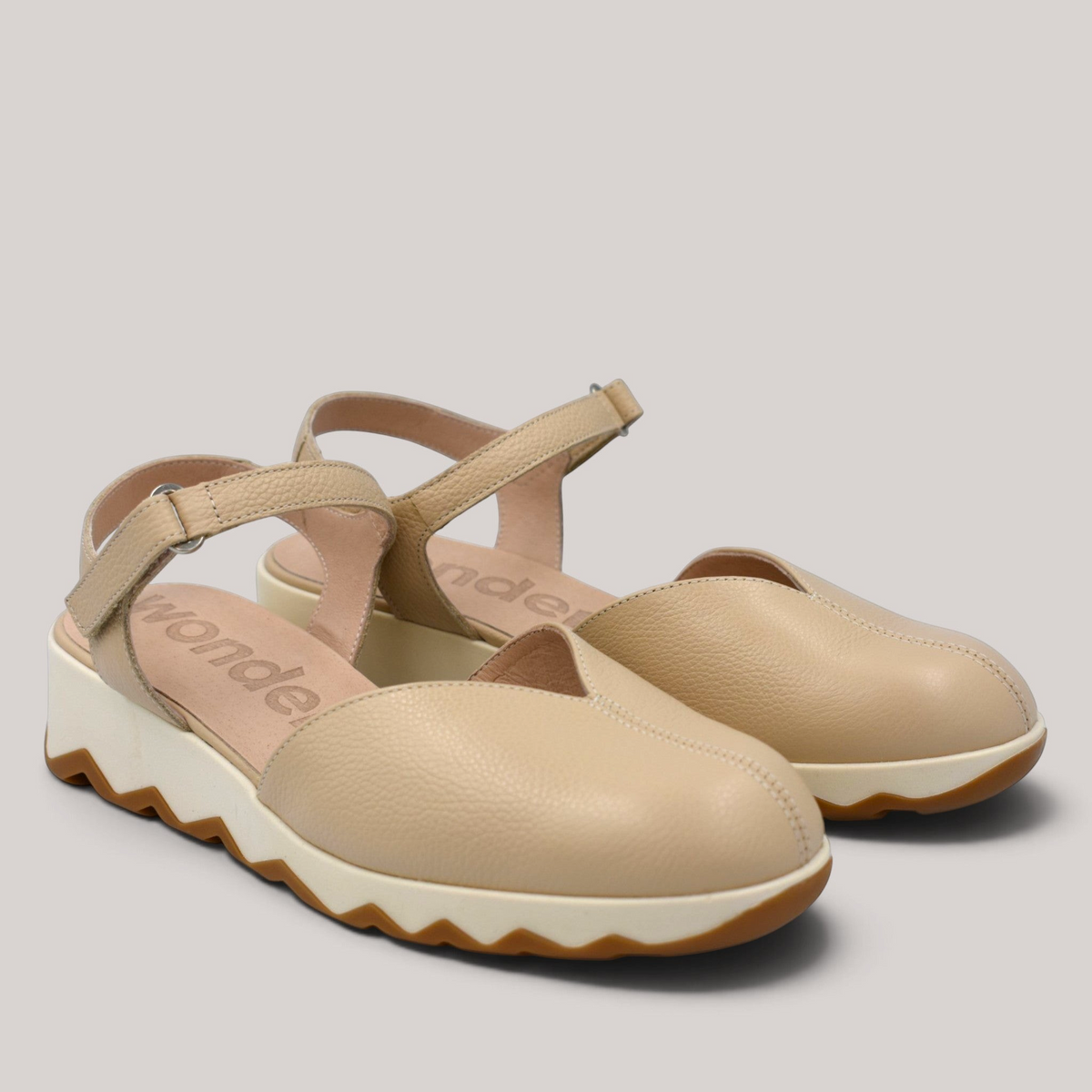 Grundy's Shoes Wonders 7601 beige leather slingback shoes with a cushioned EvoLight sole and side buckle closure.