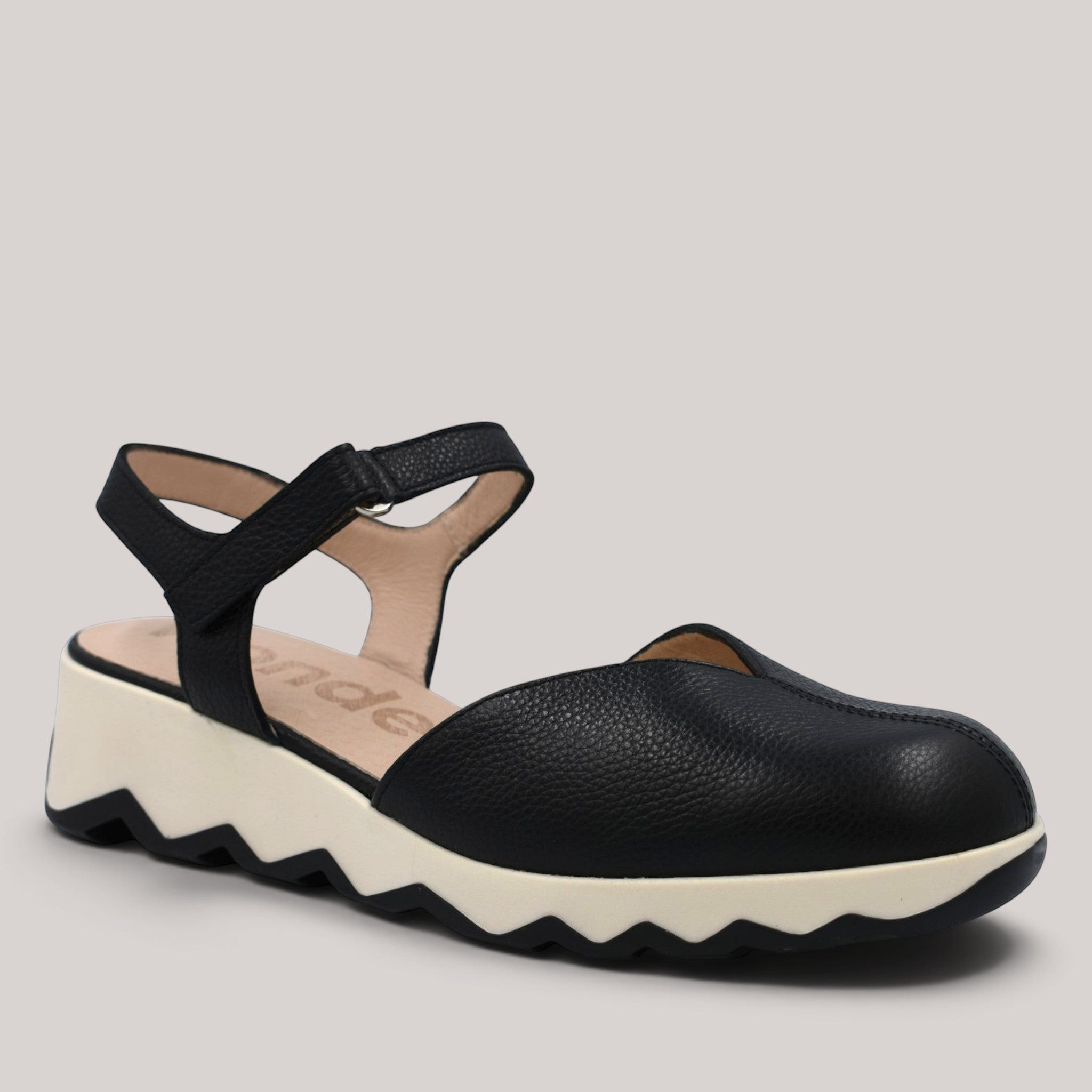 Grundy's Shoes Wonders 7601 black leather slingback shoe with a white cushioned EvoLight sole and side buckle.
