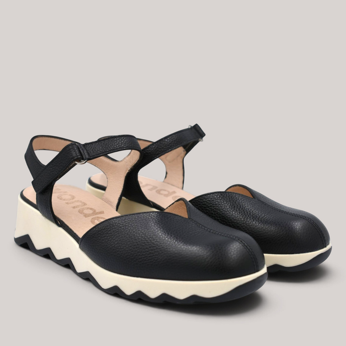 Grundy's Shoes Wonders 7601 black leather slingback shoes with a cushioned white EvoLight sole and buckle strap.