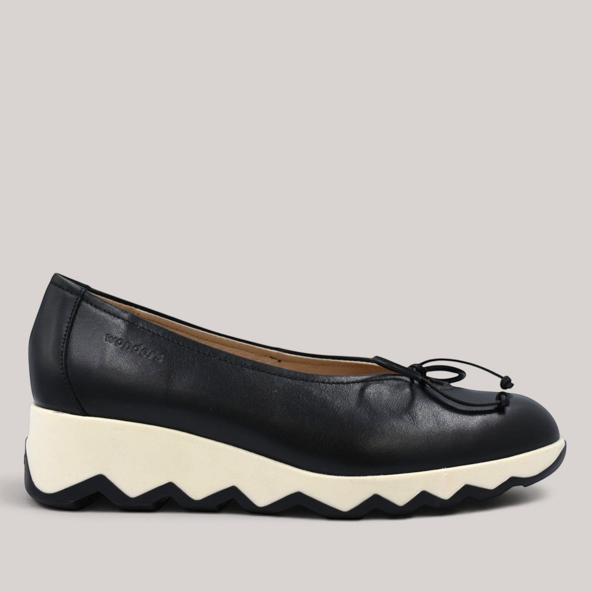 Grundy's Shoes Wonders 7621 black leather ballet wedge with a white slip-resistant sole and signature bow detail.