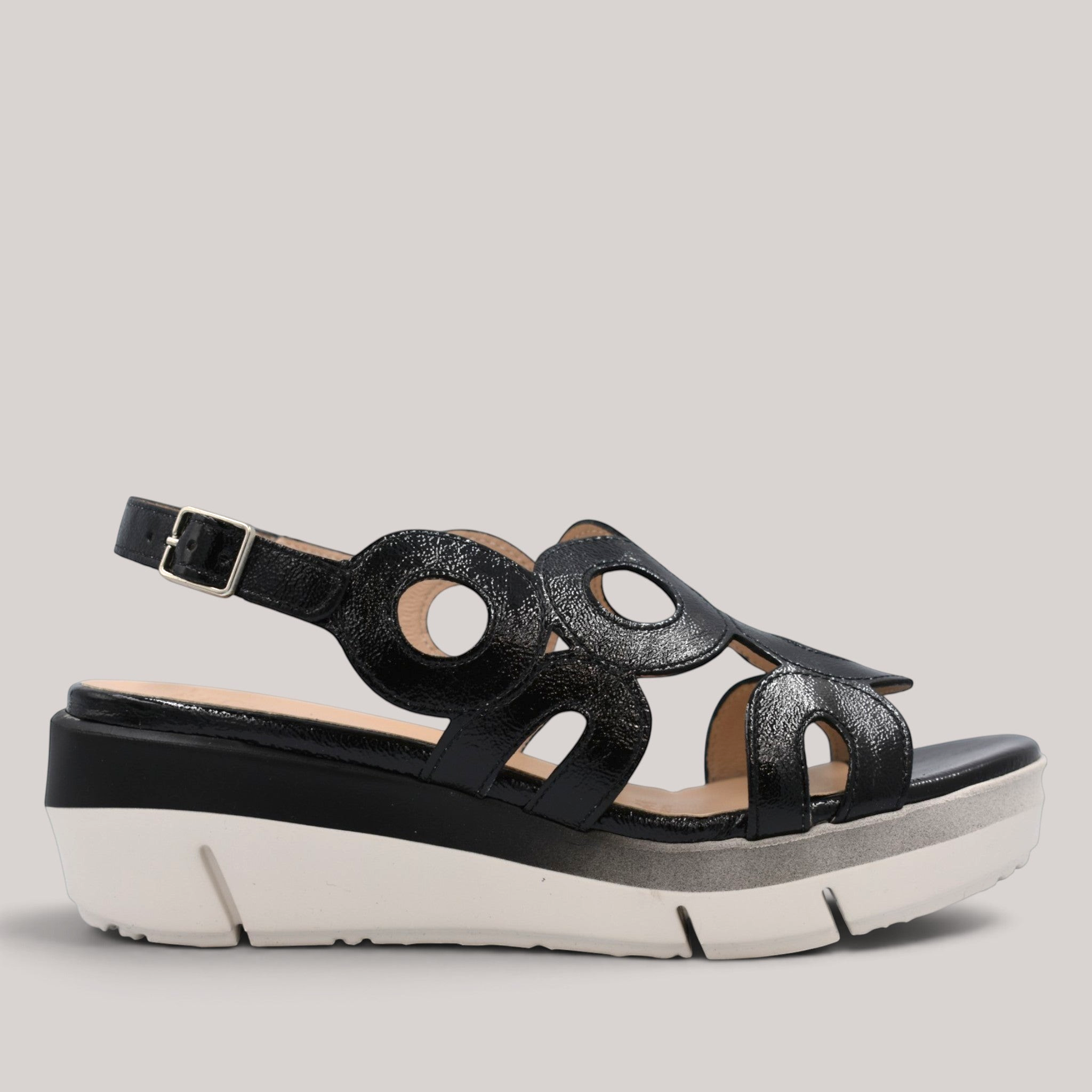 Grundy's Shoes Wonders 8282 black patent leather wedge sandals with circular cutouts and adjustable buckle strap