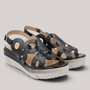 Grundy's Shoes Wonders 8282 black patent leather wedge sandals with circular cutouts and adjustable buckle closure.