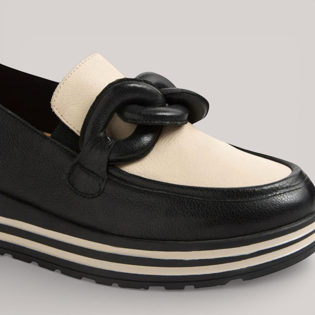 Grundy's Shoes Ziera Vyrons black and cream leather loafer with a chunky chain detail and striped platform sole.