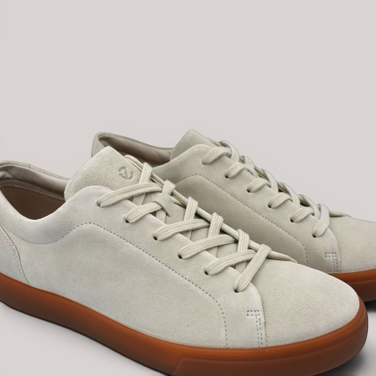 Grundy's Shoes ECCO Soft 10 men's sneakers in light grey suede with a contrasting gum rubber sole and lace-up closure.