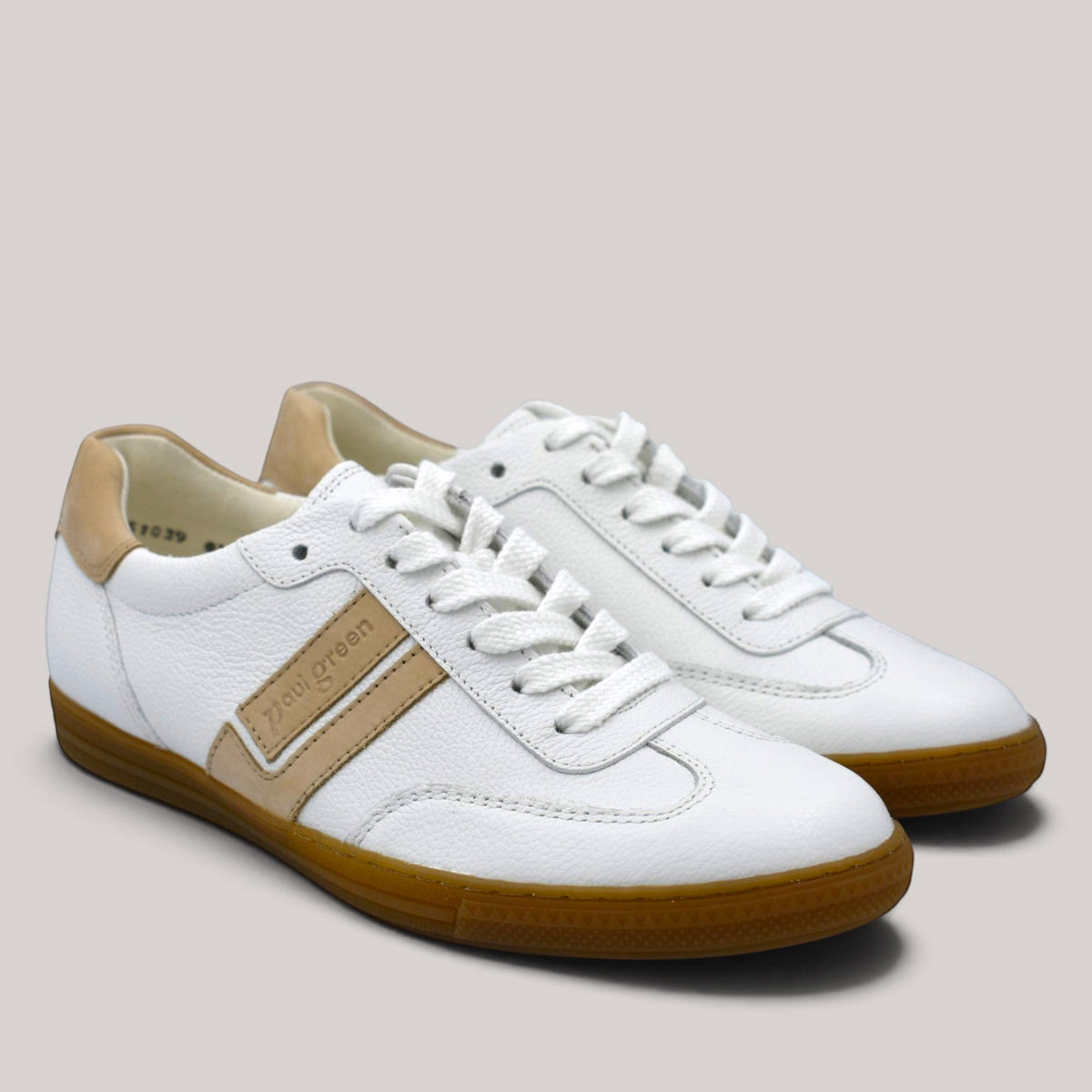 Grundy's Shoes Paul Green 5450 white leather sneakers with beige accents and a classic gum sole.