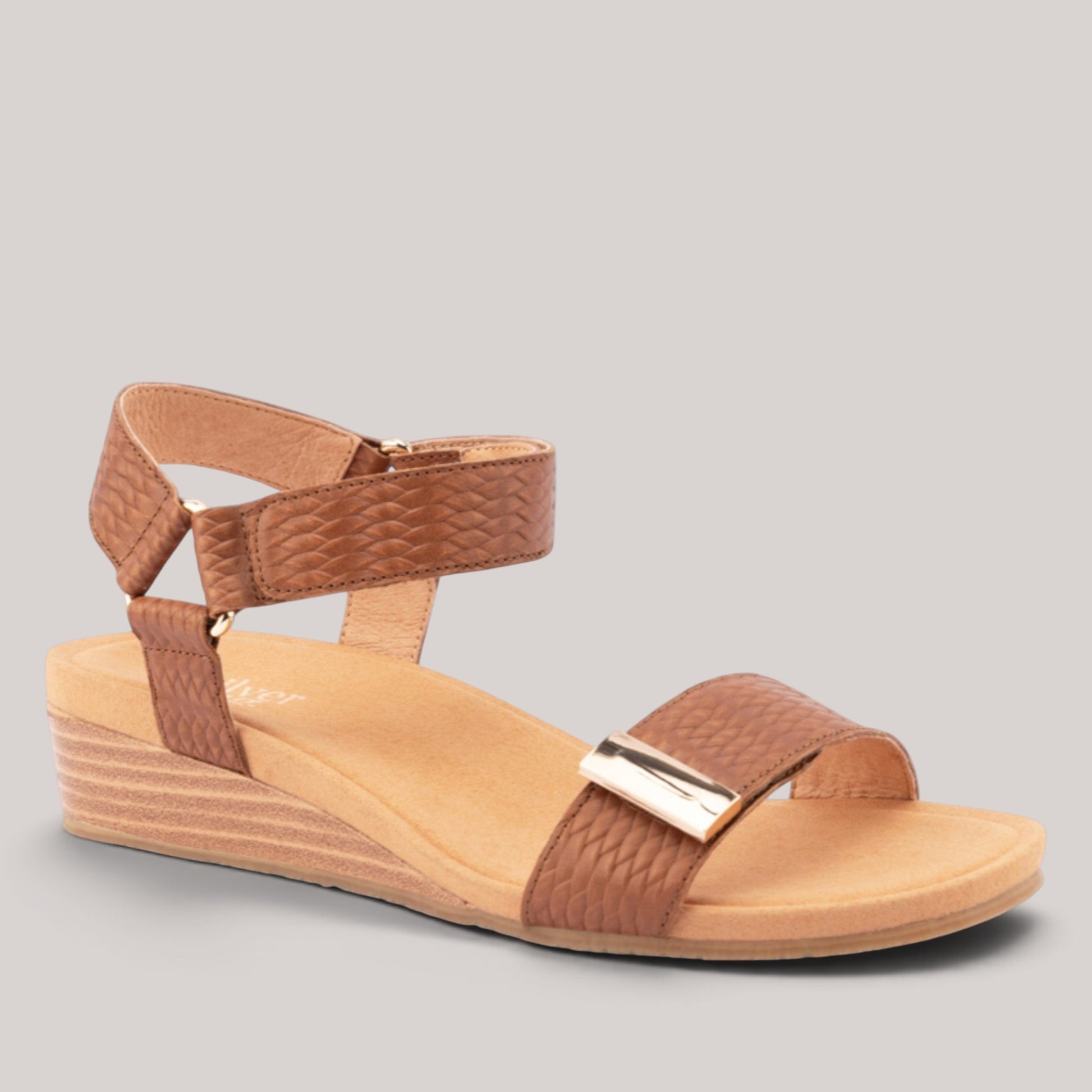 Grundy's Shoes Silver Lining Utica brown leather wedge sandals with dual velcro straps and metallic hardware detail.