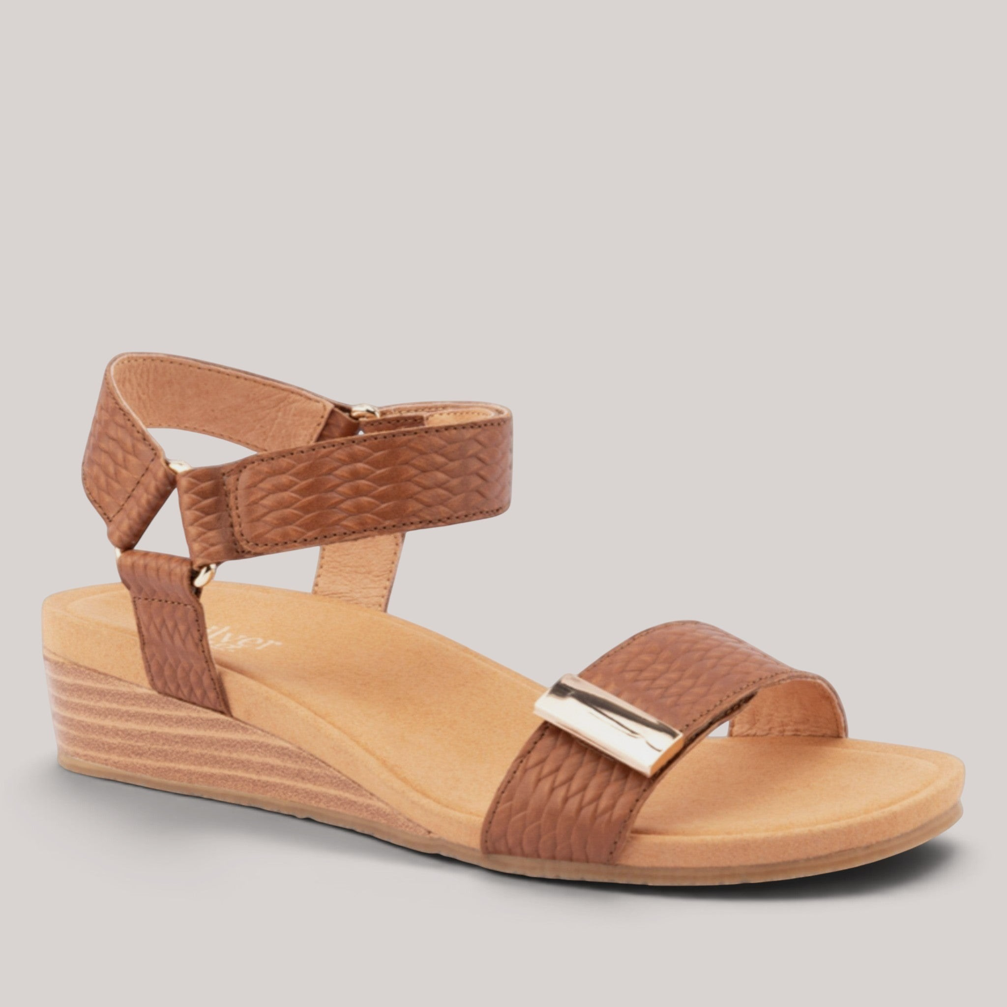 Grundy's Shoes Silver Lining Utica brown leather wedge sandals with dual velcro straps and metallic hardware detail.